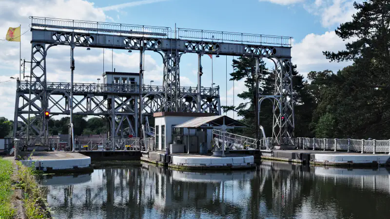 Steel gantry of boat lift no. 3 on the Canal du Centre above the canal, reflected in the water