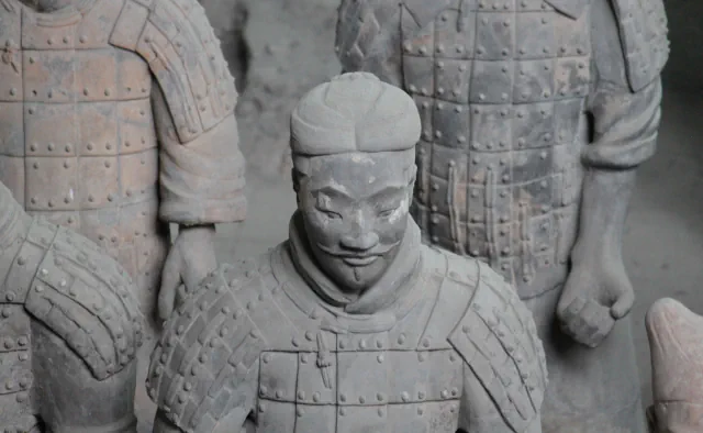 Armoured terracotta warriors in Pit 1, with a figure in the centre wearing a topknot and a thin moustache