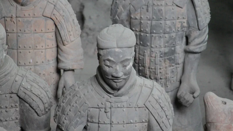 Armoured terracotta warriors in Pit 1, with a figure in the centre wearing a topknot and a thin moustache