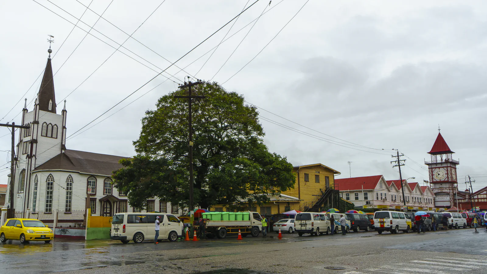 Church spire and Stabroek Market clock tower across a Georgetown street