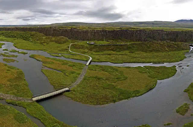 River channels, walking paths and a rocky escarpment at Þingvellir, Iceland