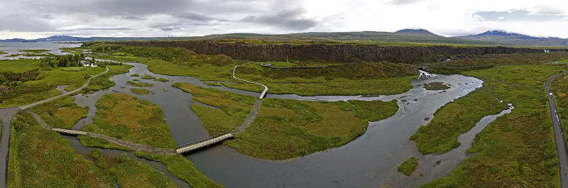 River channels, walking paths and a rocky escarpment at Þingvellir, Iceland