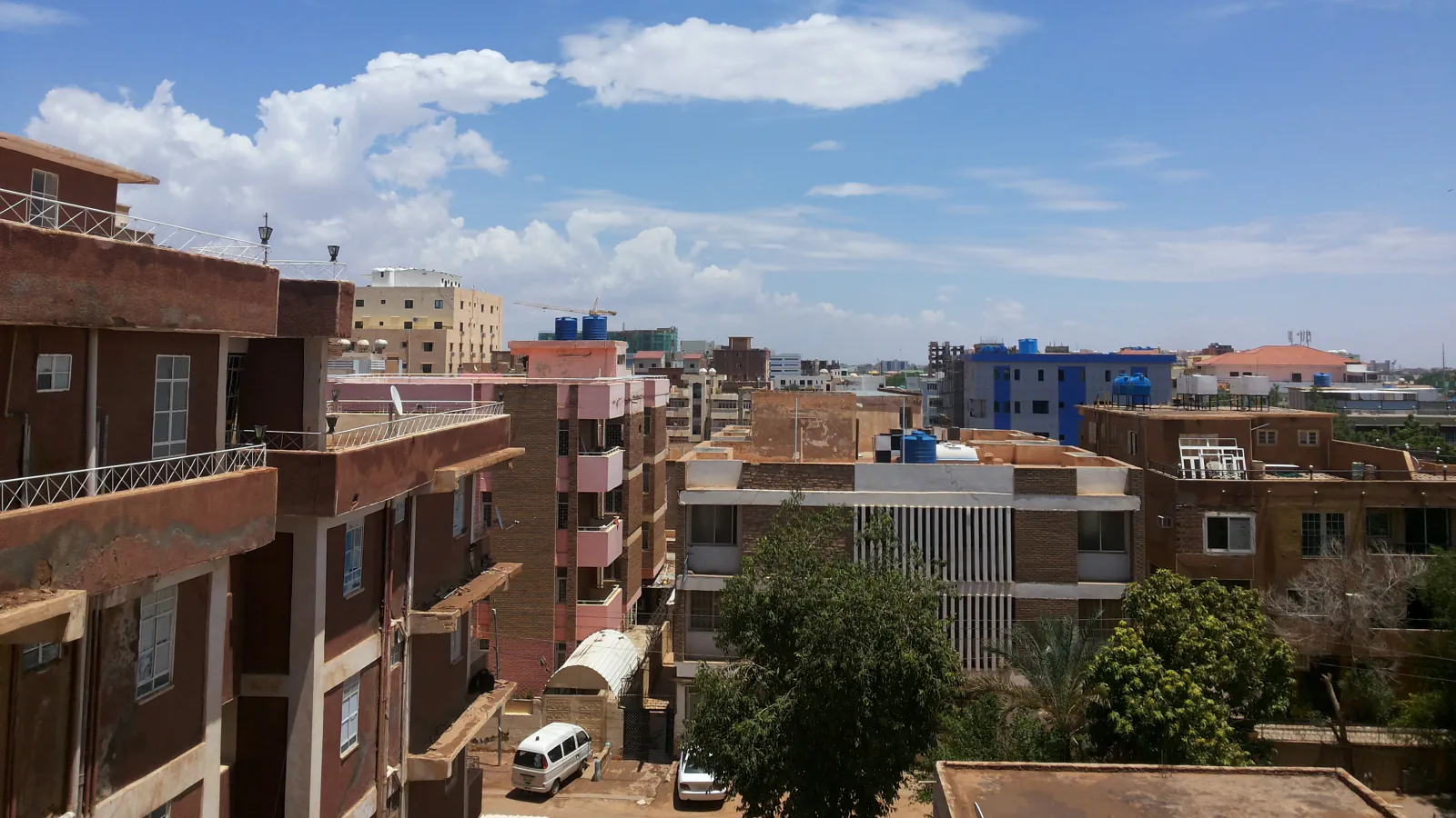Rooftops and apartment buildings in Khartoum viewed from above.