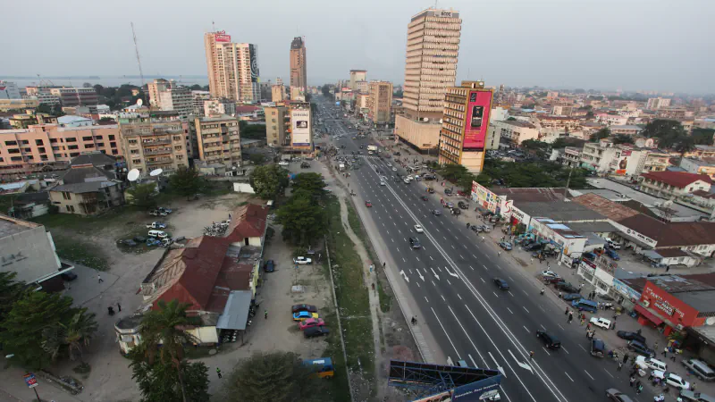 Wide Kinshasa boulevard and city buildings in daylight