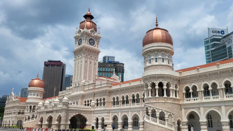 Clock tower, domes and arched façade of Sultan Abdul Samad Building in Kuala Lumpur