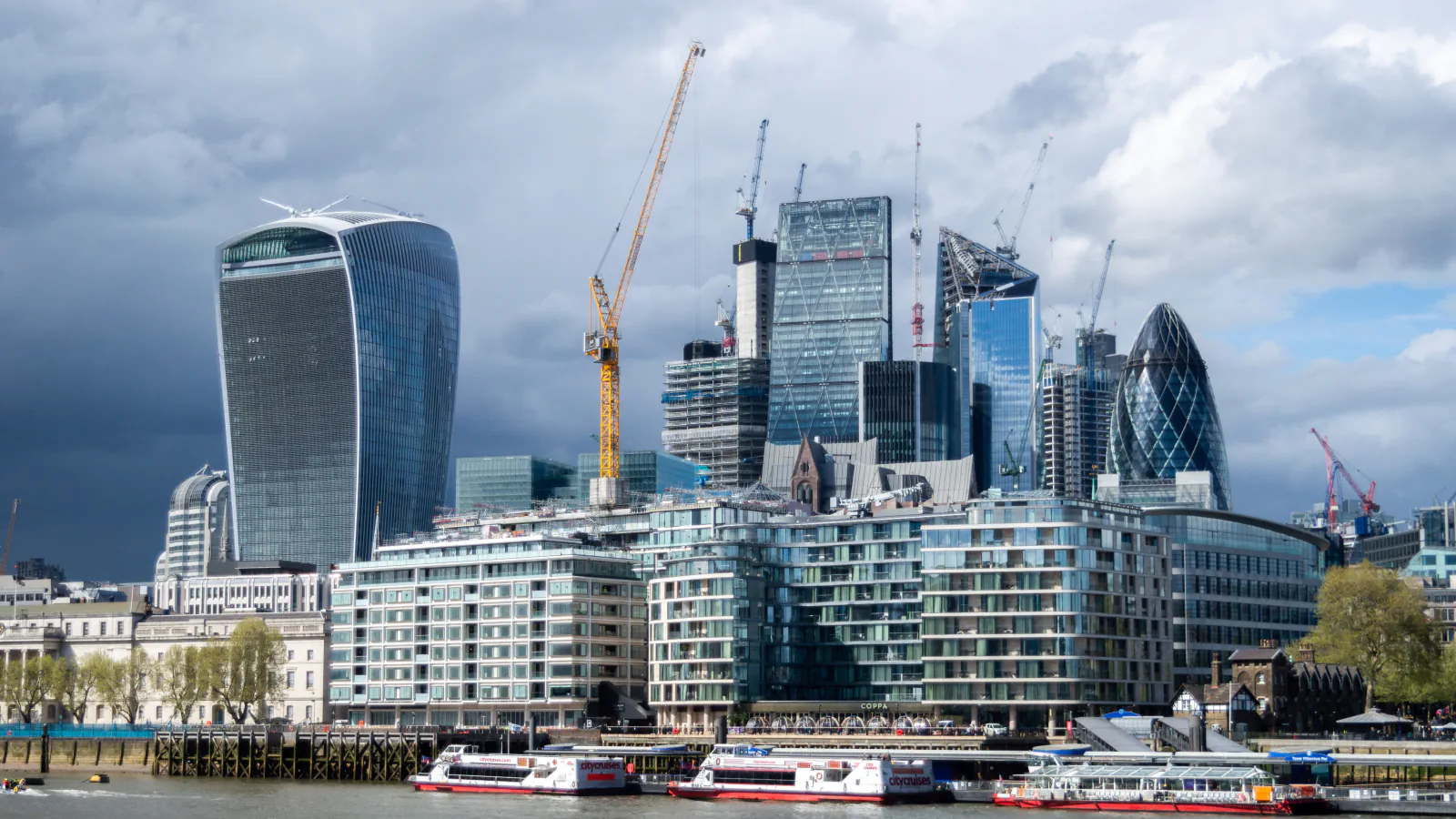 City towers and construction cranes along the Thames, 2018.