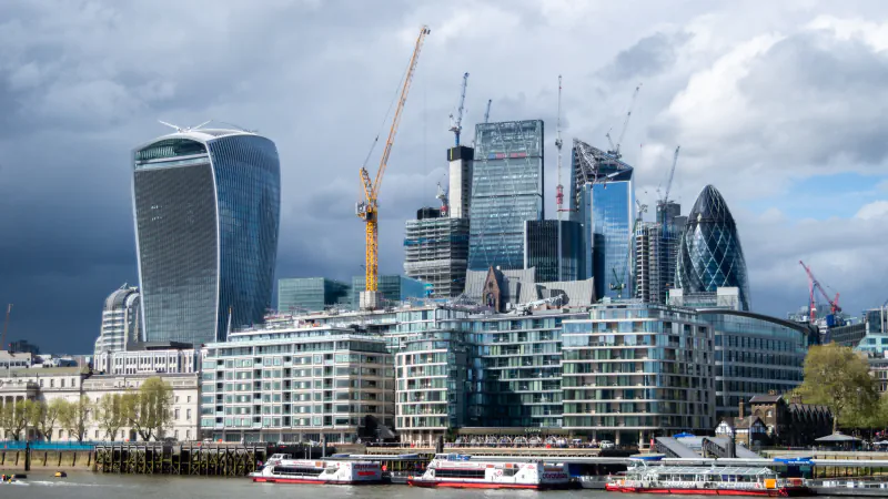 City towers and construction cranes along the Thames, 2018.