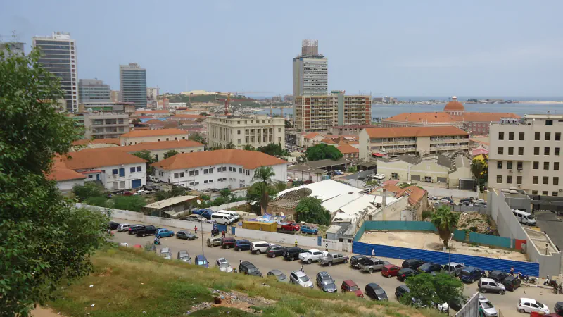 Luanda’s Baixa rooftops and office towers seen from higher ground, with the bay beyond
