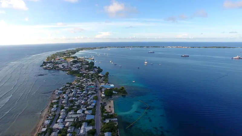 Aerial view of Rita’s narrow built strip between the ocean and lagoon at Majuro