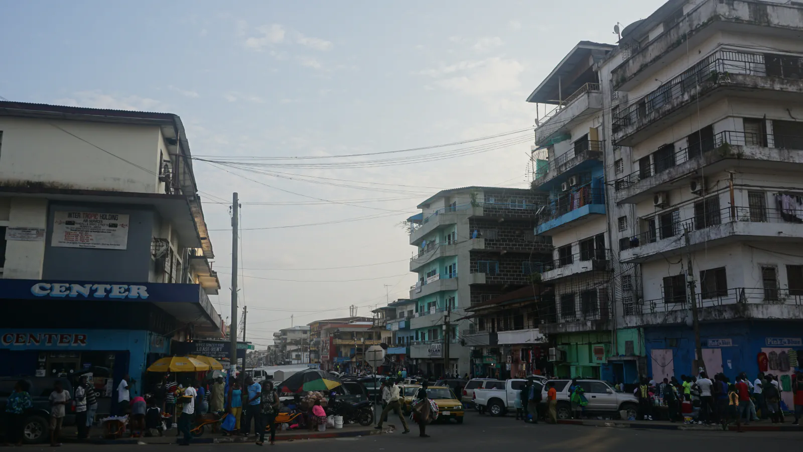 Central Monrovia street with multi-storey buildings and roadside stalls