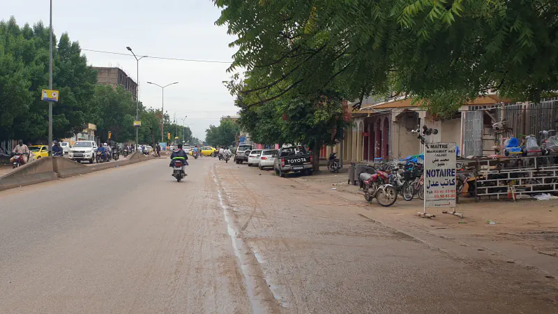 Broad street in N’Djamena with low buildings and distant traffic