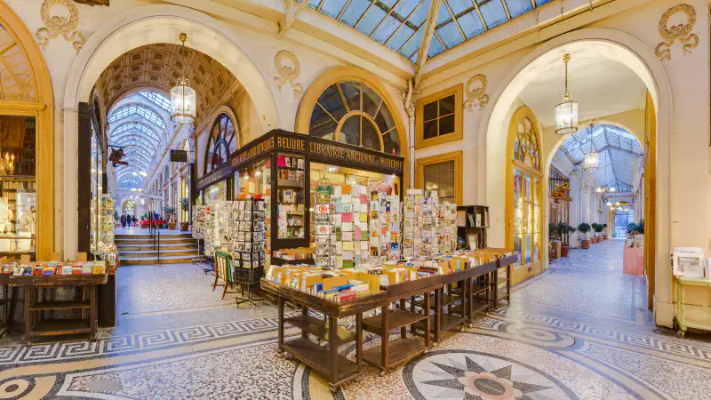 Knjigarniške stojnice, mozaična tla in zastekljena streha v pariški Galerie Vivienne