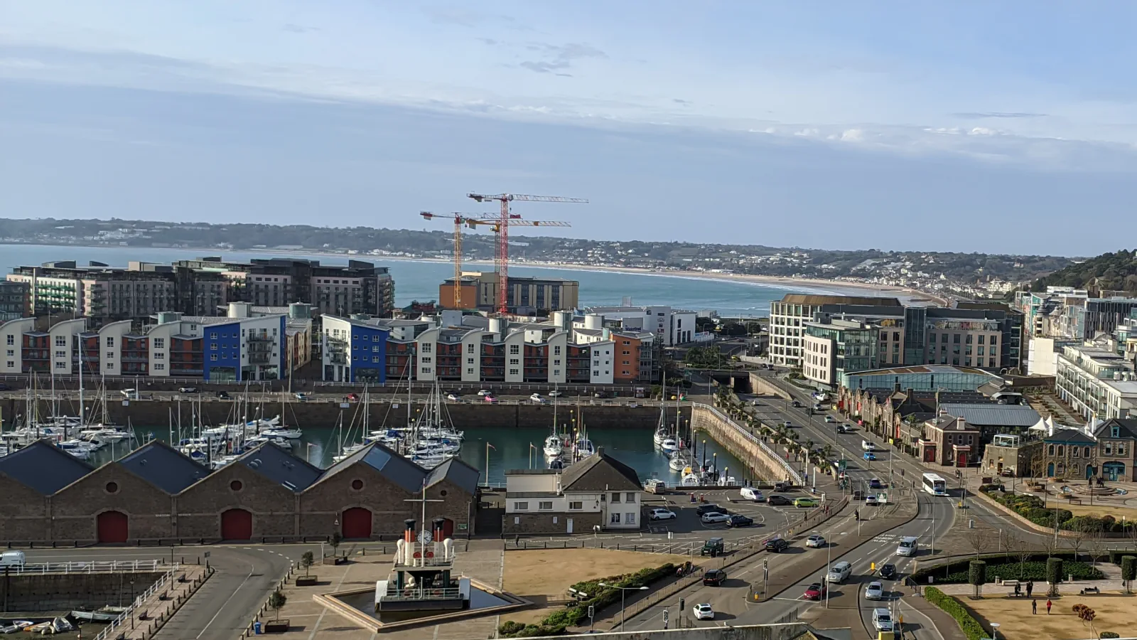 Saint Helier harbour, boats, quayside buildings and bay seen from above