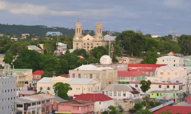 Saint John’s rooftops and cathedral towers beneath a cloudy sky