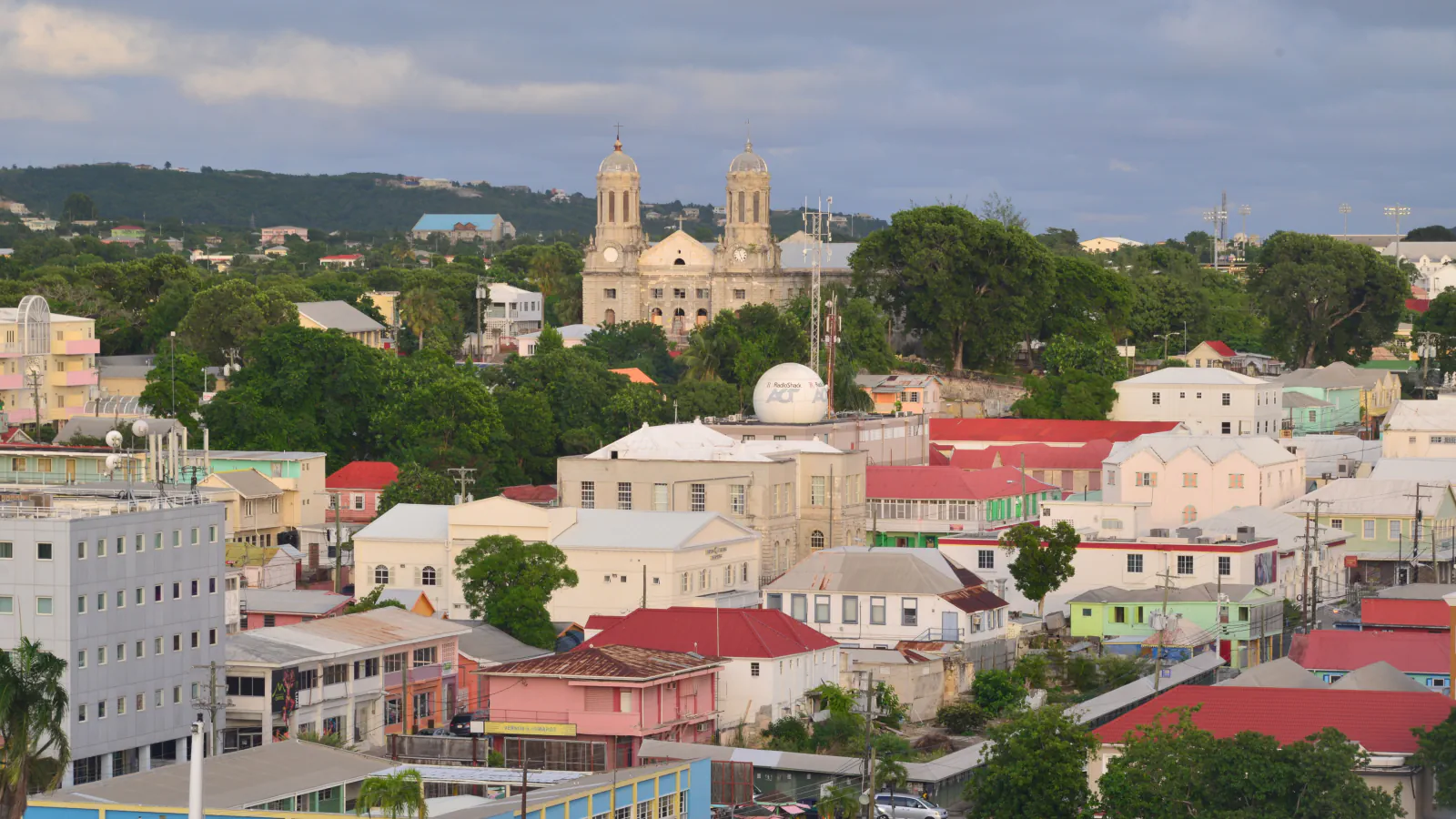 Saint John’s rooftops and cathedral towers beneath a cloudy sky