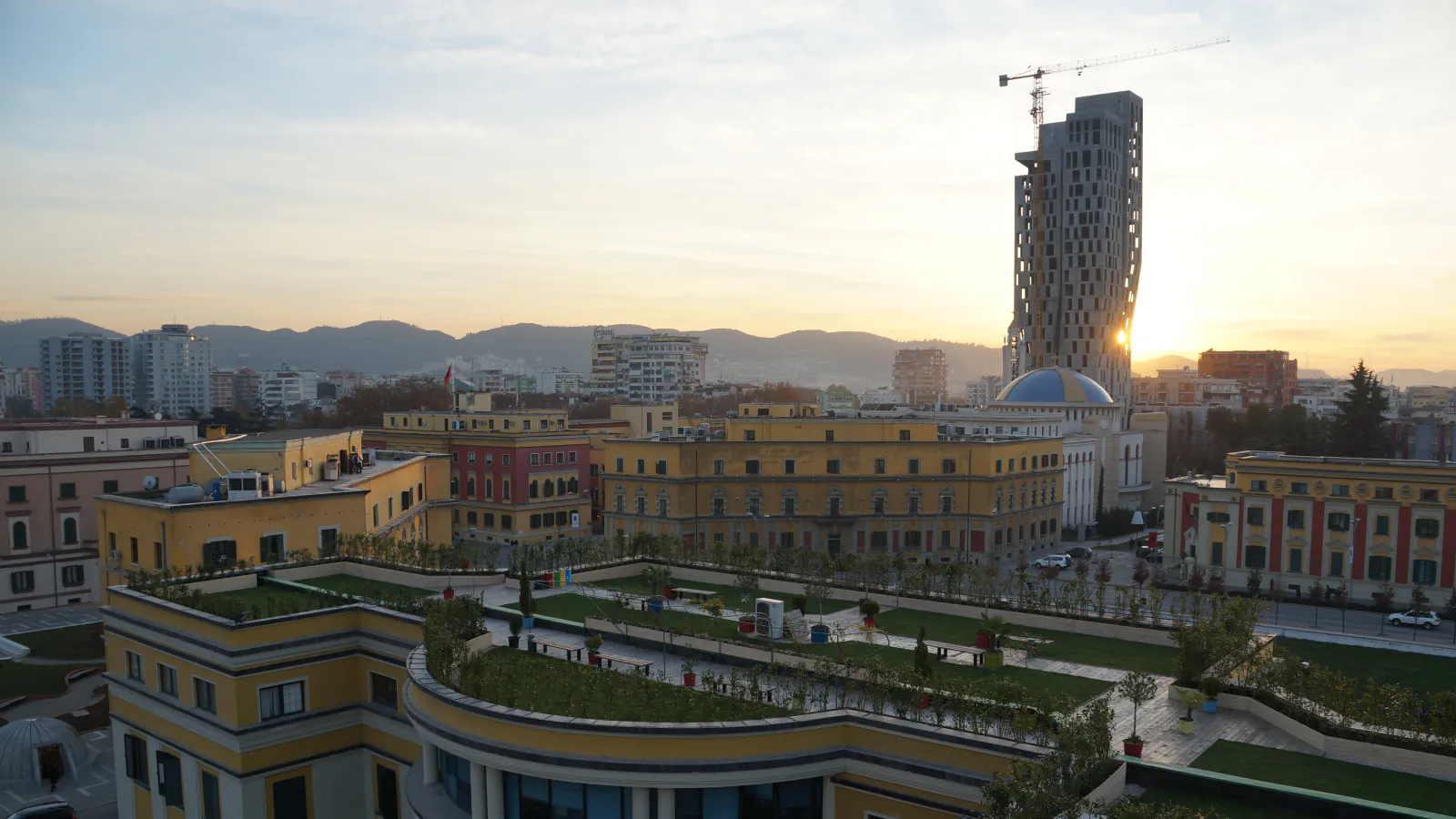 Tirana buildings and a tall tower at sunset, seen from the Clock Tower
