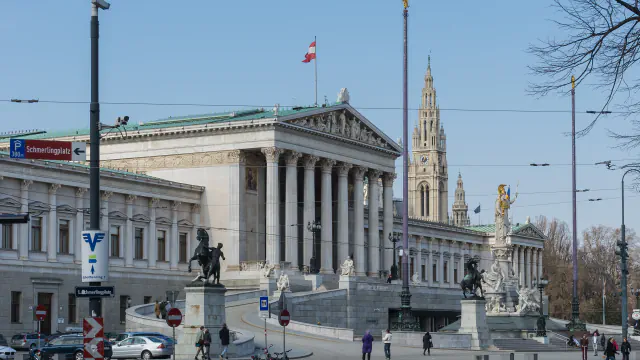 The Austrian Parliament building on the Ringstrasse, with the tower of Vienna’s Rathaus rising behind it