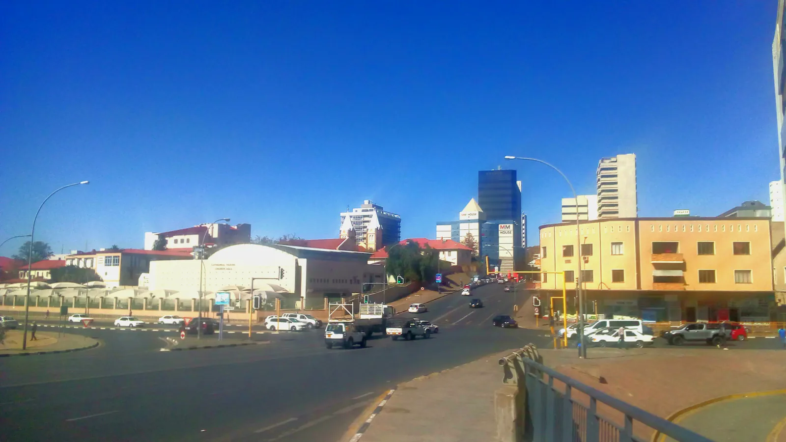 Windhoek street, trees and low buildings under a blue sky