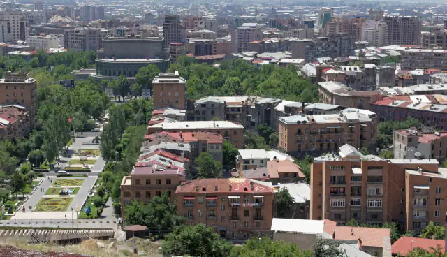 Tree-lined street and densely built central Yerevan seen from above