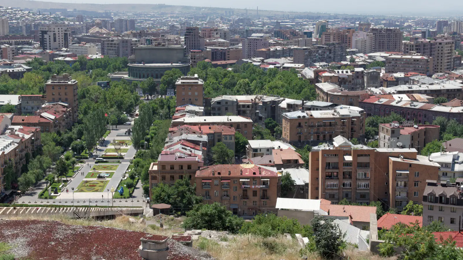 Tree-lined street and densely built central Yerevan seen from above